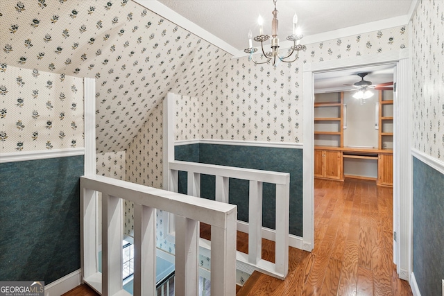 interior space featuring an inviting chandelier, crown molding, and light wood-type flooring