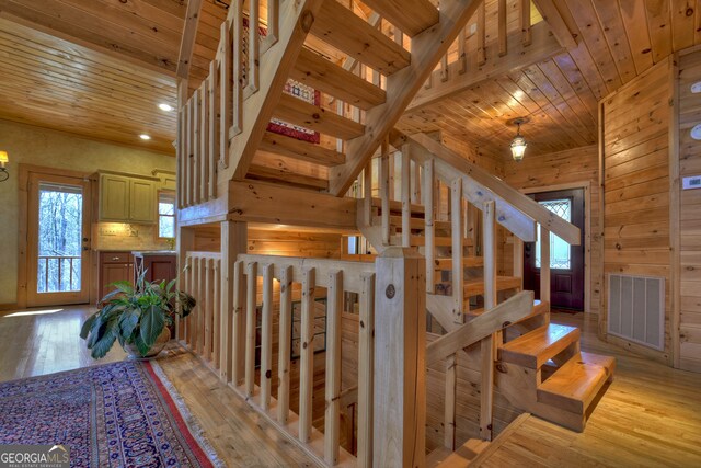 stairway featuring wooden ceiling and hardwood / wood-style floors