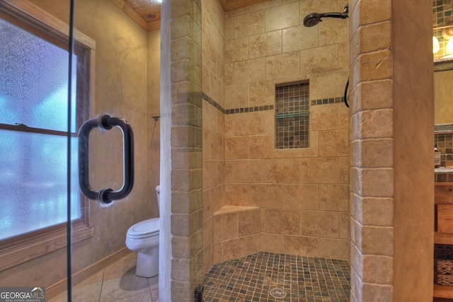 bathroom featuring toilet, an enclosed shower, and tile patterned floors