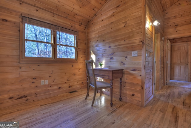 office space with light wood-type flooring, wood walls, wood ceiling, and lofted ceiling