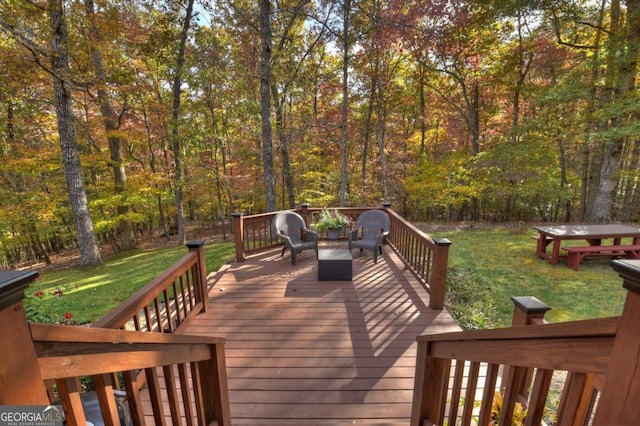 wooden deck featuring a lawn