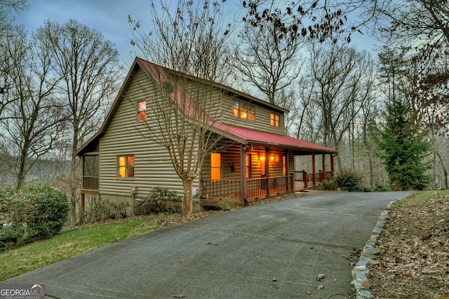 view of side of property featuring covered porch