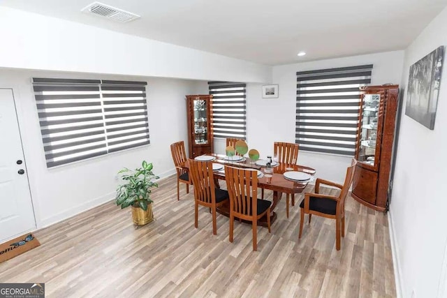 dining space with light hardwood / wood-style flooring