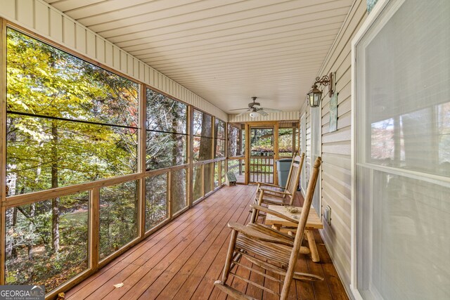 sunroom / solarium featuring ceiling fan