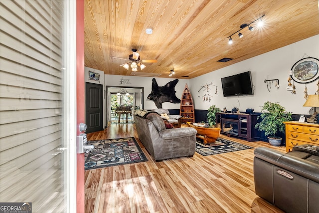 living room with wood ceiling, a fireplace, ceiling fan, and light hardwood / wood-style flooring