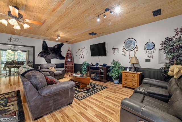 living room with ceiling fan, wooden ceiling, track lighting, a fireplace, and light wood-type flooring