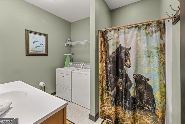 laundry area with separate washer and dryer, light tile floors, and sink