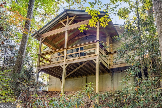 back of property featuring a balcony