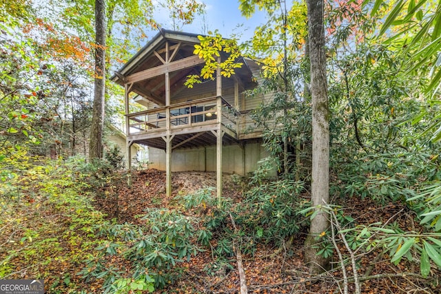 rear view of house featuring a wooden deck