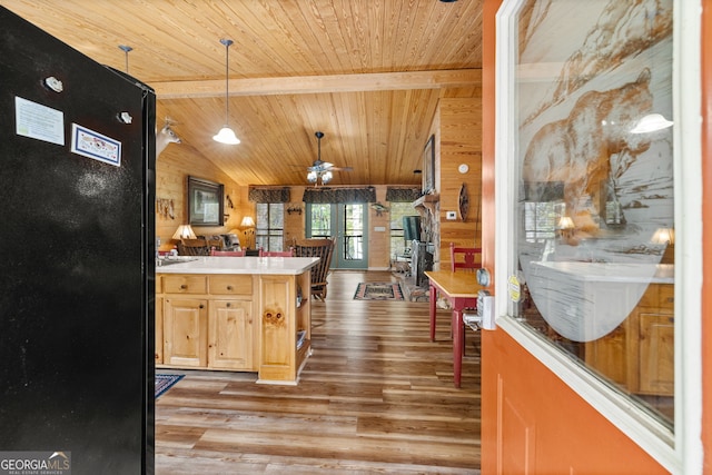 kitchen featuring light brown cabinets, light wood-type flooring, pendant lighting, ceiling fan, and wood ceiling