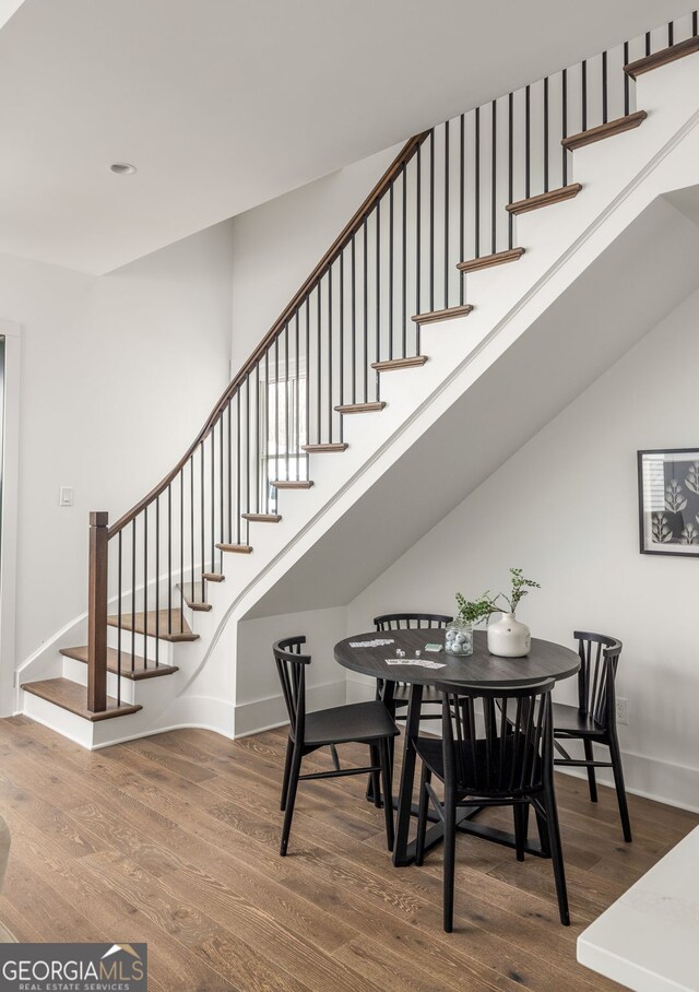 staircase with hardwood / wood-style floors