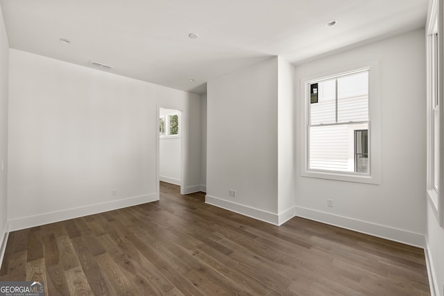 unfurnished room featuring dark hardwood / wood-style flooring