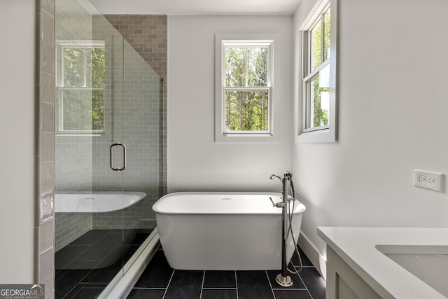 bathroom with tile patterned flooring, vanity, and shower with separate bathtub