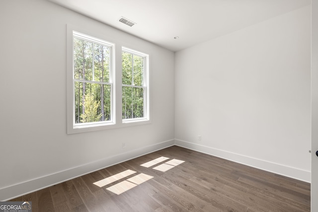 empty room with dark hardwood / wood-style floors