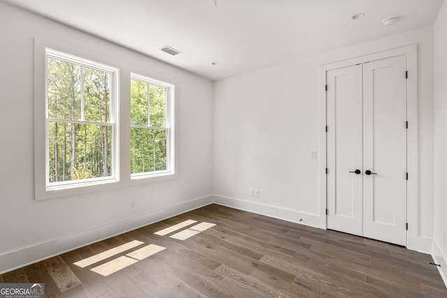 unfurnished bedroom featuring dark hardwood / wood-style flooring