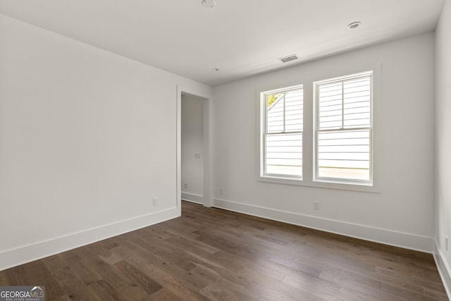 unfurnished room featuring dark hardwood / wood-style floors