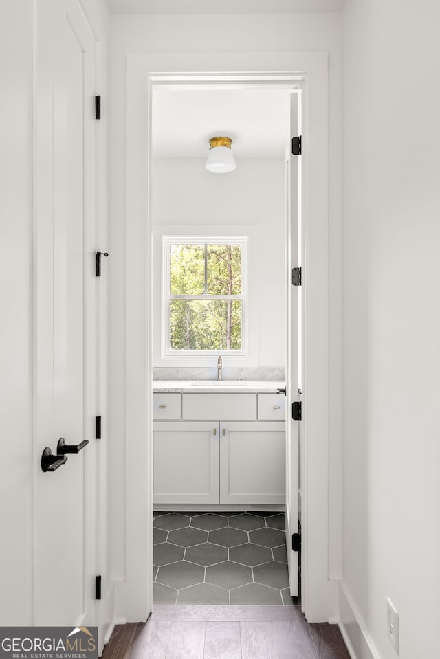 interior space featuring dark tile patterned floors and sink