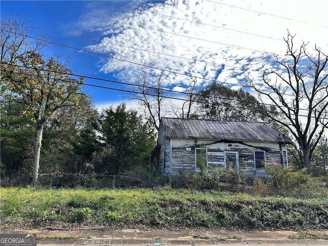 view of property exterior featuring an outdoor structure