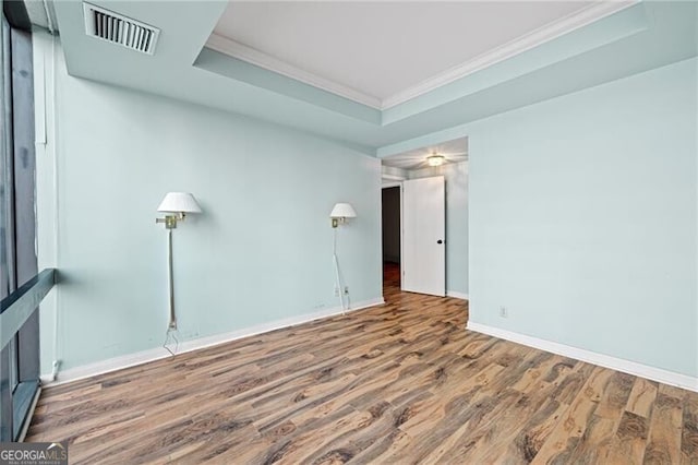 unfurnished room featuring hardwood / wood-style flooring and ornamental molding