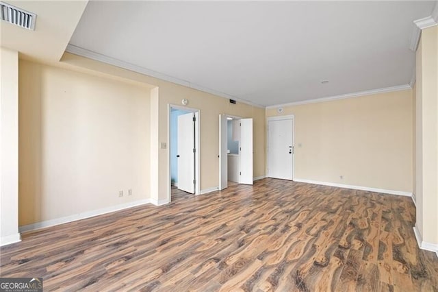 spare room with crown molding and dark hardwood / wood-style flooring