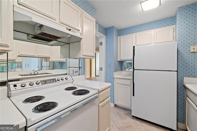 kitchen featuring white cabinets, white appliances, light parquet floors, and sink