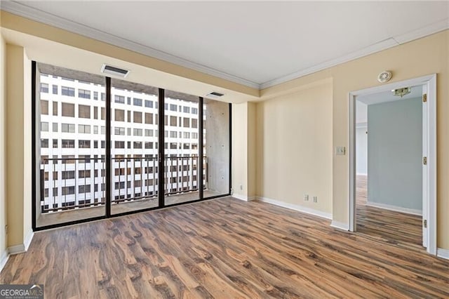 spare room with crown molding and dark hardwood / wood-style floors