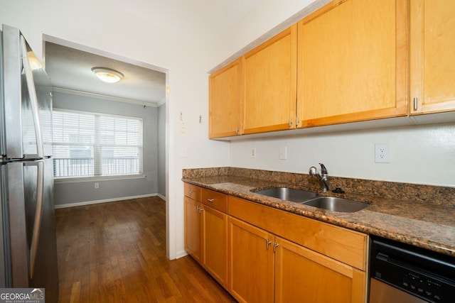 kitchen with crown molding, dark wood-type flooring, appliances with stainless steel finishes, sink, and dark stone countertops