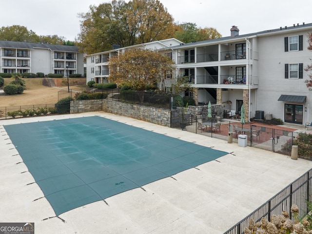 view of swimming pool featuring central AC