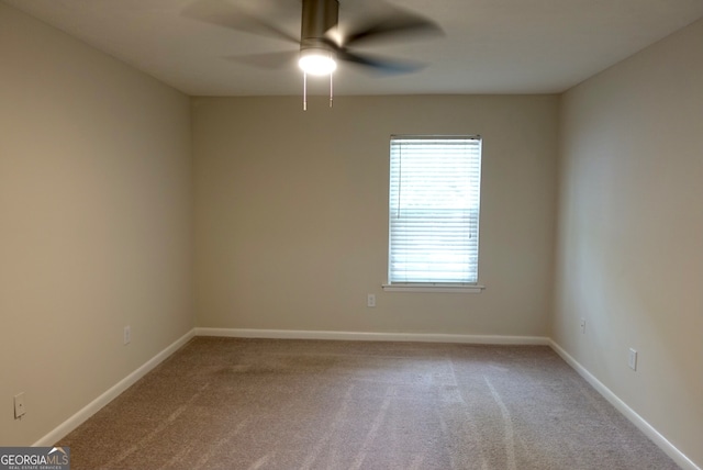 carpeted empty room featuring ceiling fan