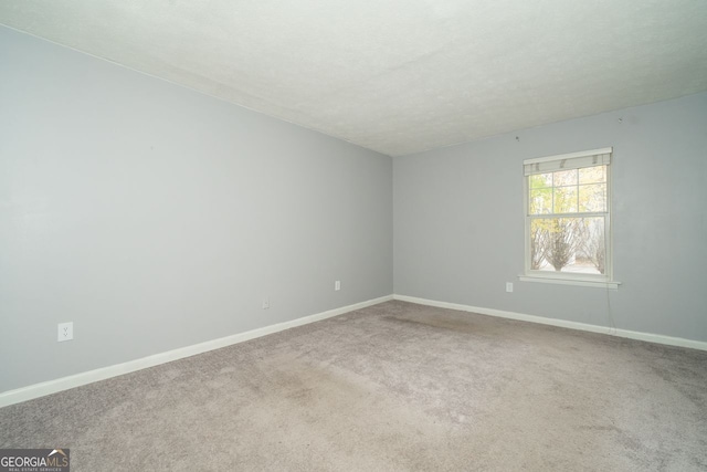 unfurnished room featuring carpet