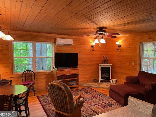 living room featuring wood walls, wooden ceiling, light hardwood / wood-style flooring, and an AC wall unit