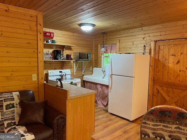 kitchen with white appliances, wooden ceiling, light wood-type flooring, and wood walls