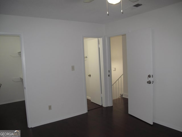 spare room featuring ceiling fan and dark hardwood / wood-style floors