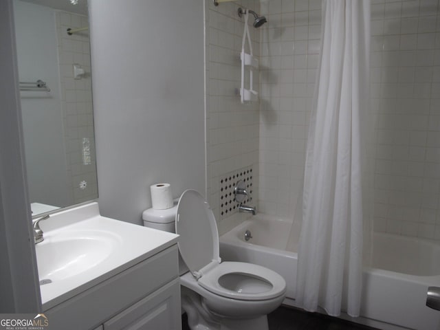 full bathroom featuring vanity, shower / bath combo with shower curtain, and toilet