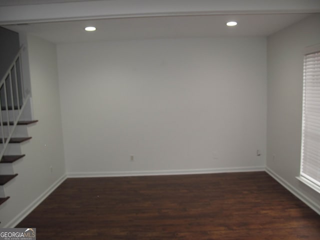 unfurnished room with dark hardwood / wood-style flooring