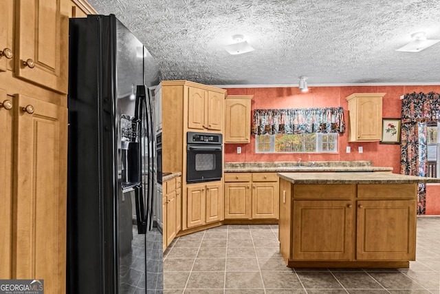 kitchen featuring black appliances, a textured ceiling, a kitchen island, and light tile floors