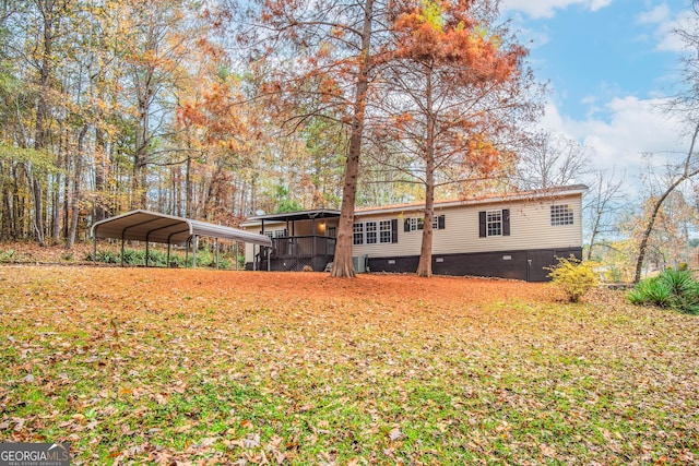 rear view of property with a carport