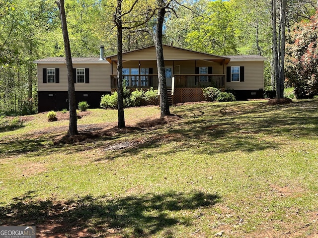 view of front facade featuring a wooden deck and a front yard