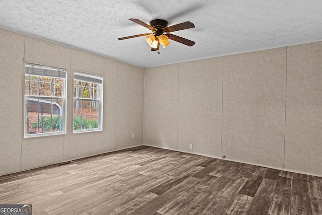 unfurnished room with hardwood / wood-style floors, ceiling fan, and a textured ceiling