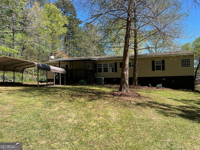 back of property featuring central air condition unit, a carport, and a lawn