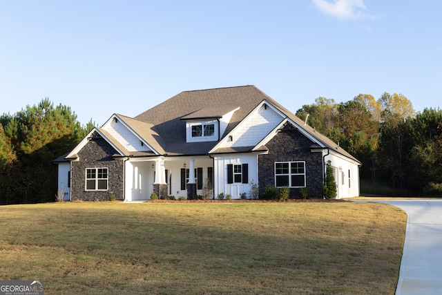 view of front of house with a front yard and a porch