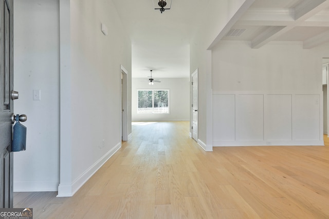 corridor featuring light hardwood / wood-style floors, beamed ceiling, and coffered ceiling