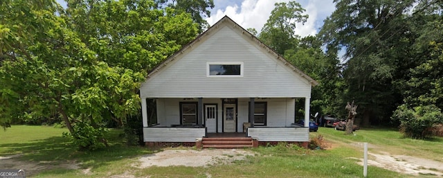 bungalow-style house featuring a front lawn and covered porch