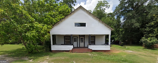 bungalow featuring a porch and a front lawn