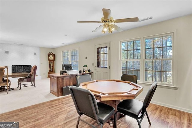 dining space featuring light wood-type flooring, a wealth of natural light, and ceiling fan