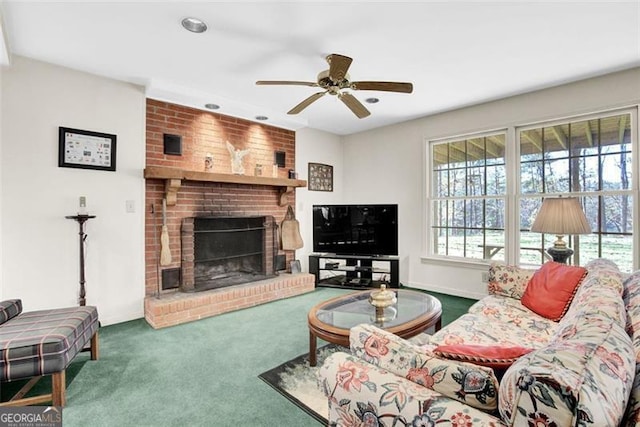 carpeted living room with a fireplace and ceiling fan