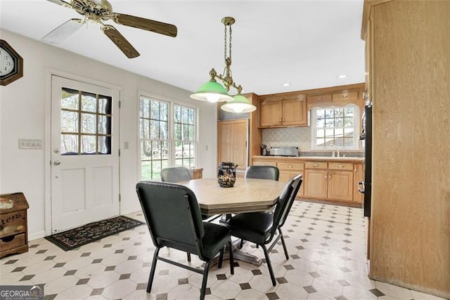 dining area with ceiling fan and sink