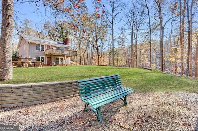 surrounding community featuring a lawn and a wooden deck