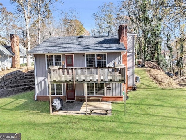 rear view of house with a yard and a patio area