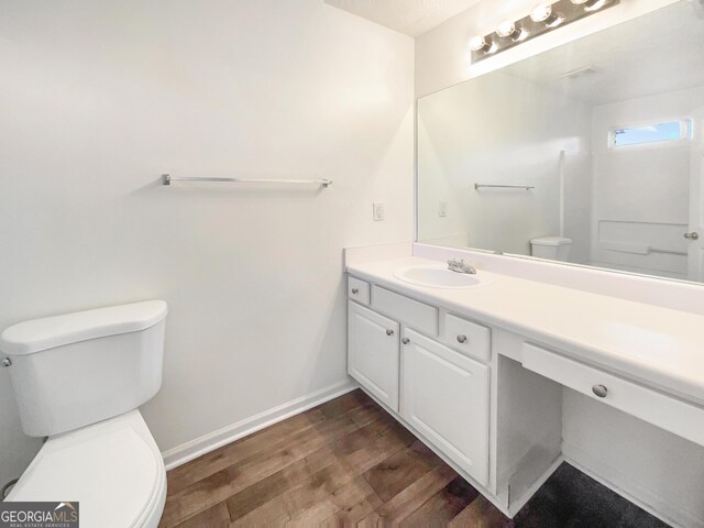 bathroom featuring hardwood / wood-style floors, vanity, and toilet